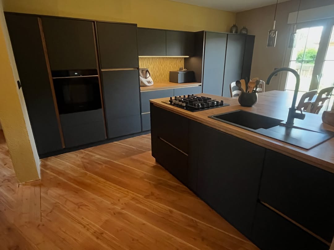 Dunkle Küche mit Gaskochfeld und warmem Holzboden